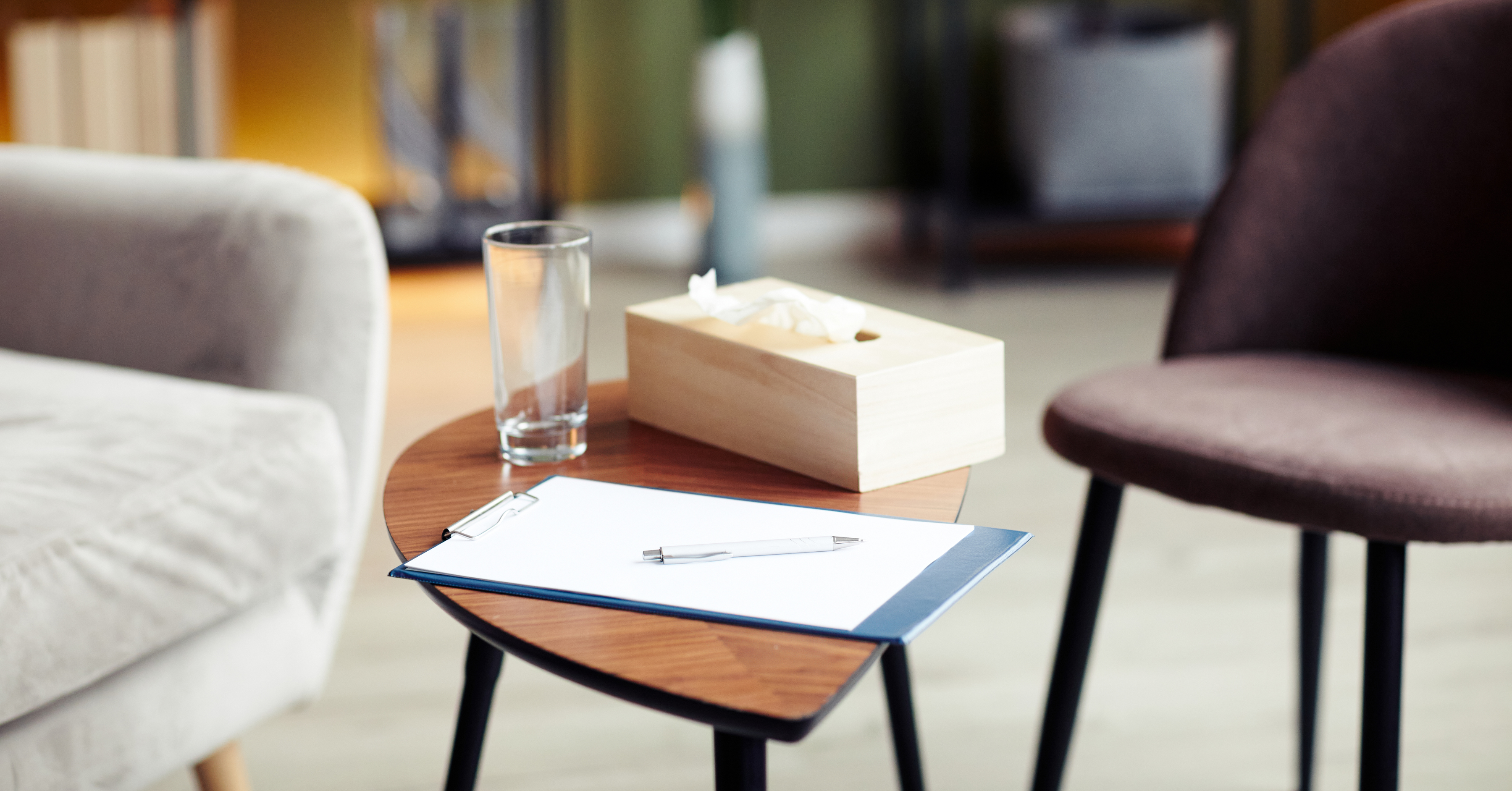 therapist notebook, tissues, and water for counseling session