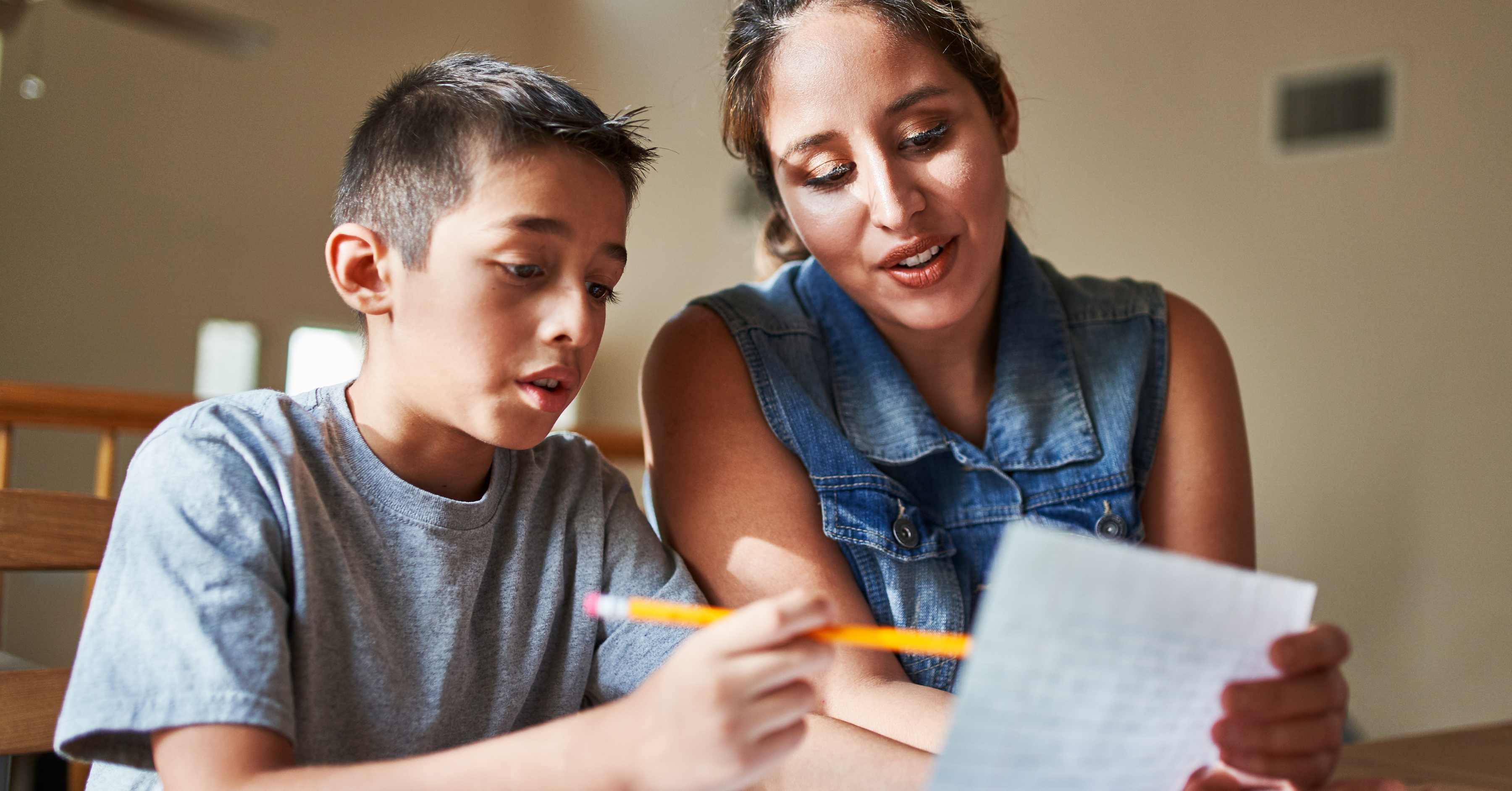 adolescent boy reviewing standardized test with encouraging mom