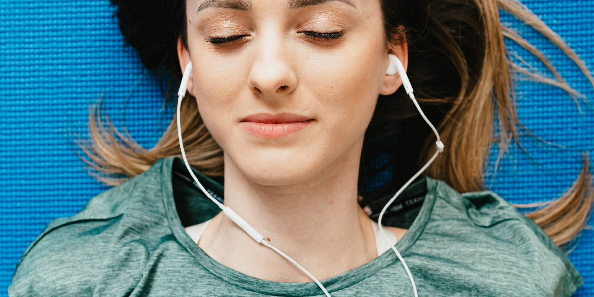 Lady enjoying a music through her headphone