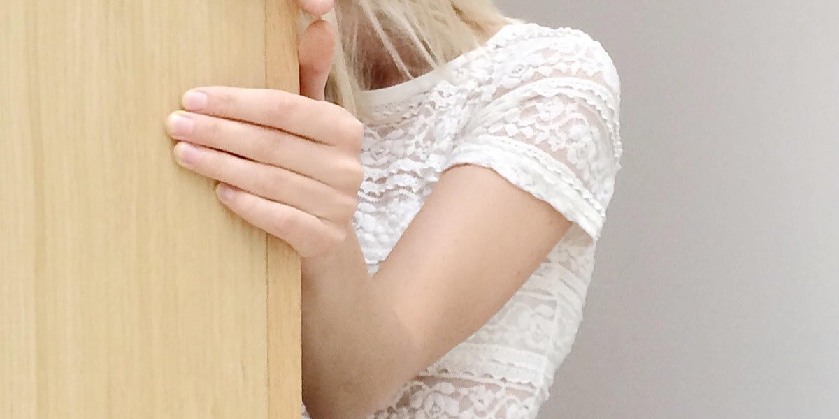 a young lady touching a wall