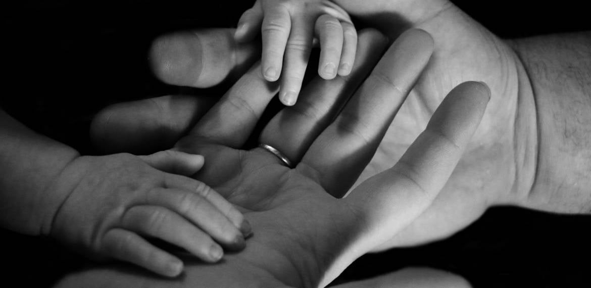 hands of a mother and her child