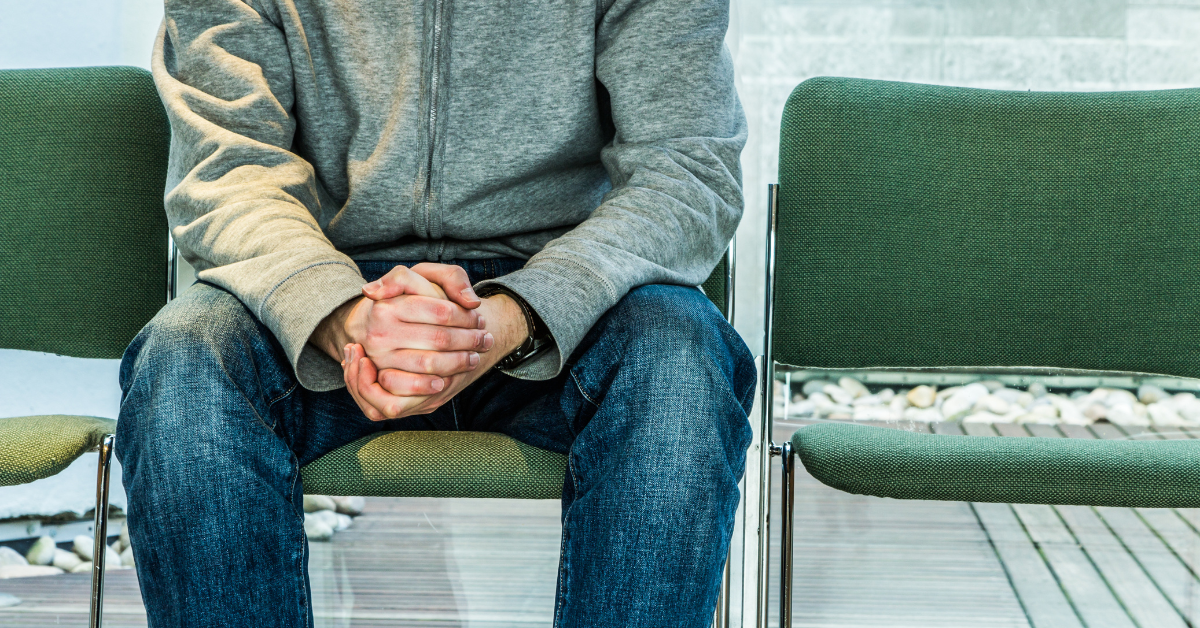 clenched hands of stressed client waiting for therapist on waitlist