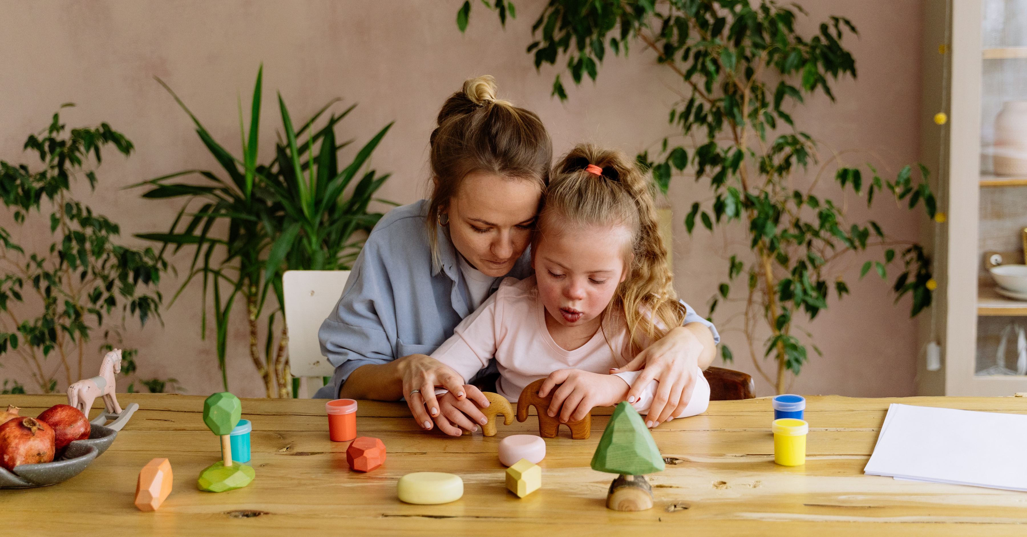 young girl with Downs syndrome doing puzzle with mom in special education setting in FL