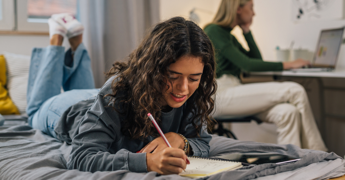 College student working with confidence in dorm room.