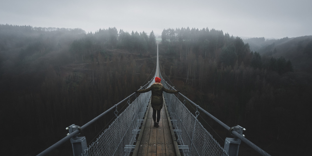 a woman crossing the bridge