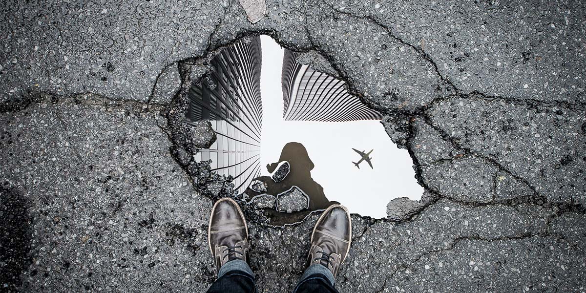 a lonely feet with a reflection of an airplane in the water