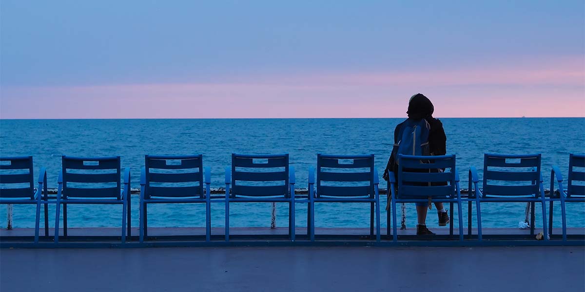 a woman alone sitting in the docks