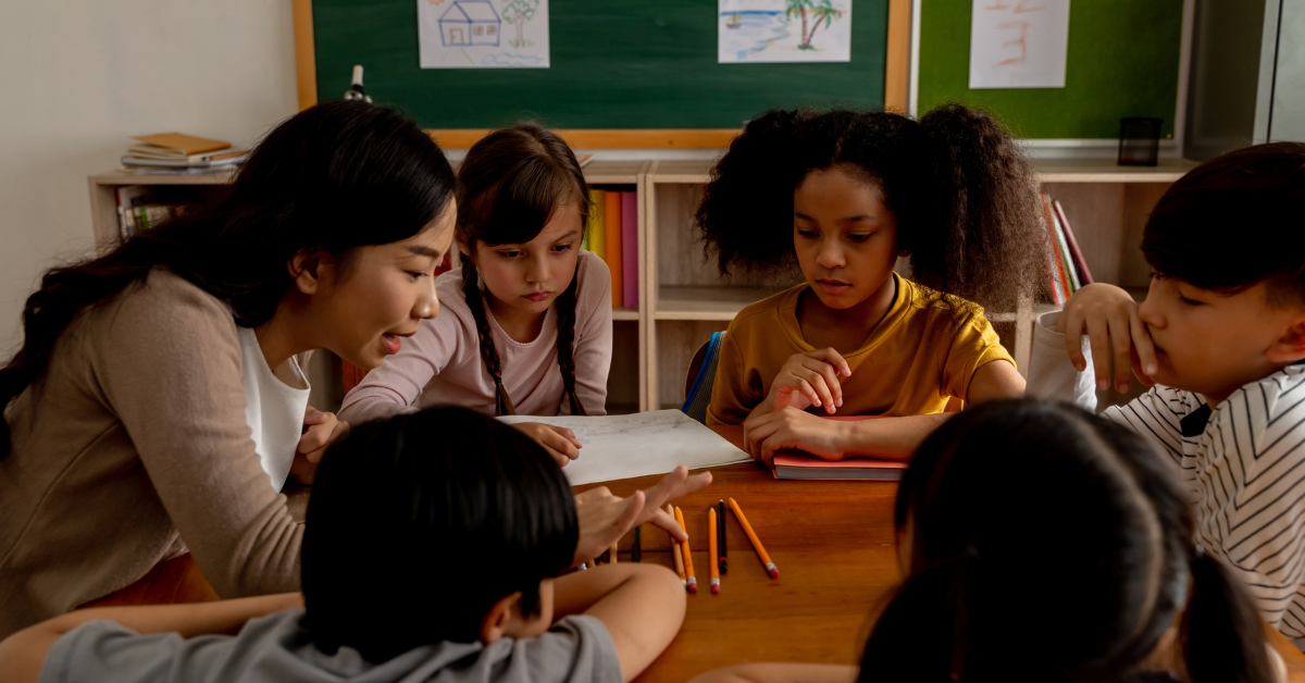 stressed out teacher leading group of young students in classroom
