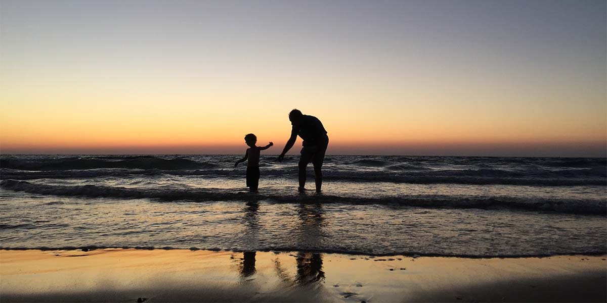 A father with his child enjoying the beach
