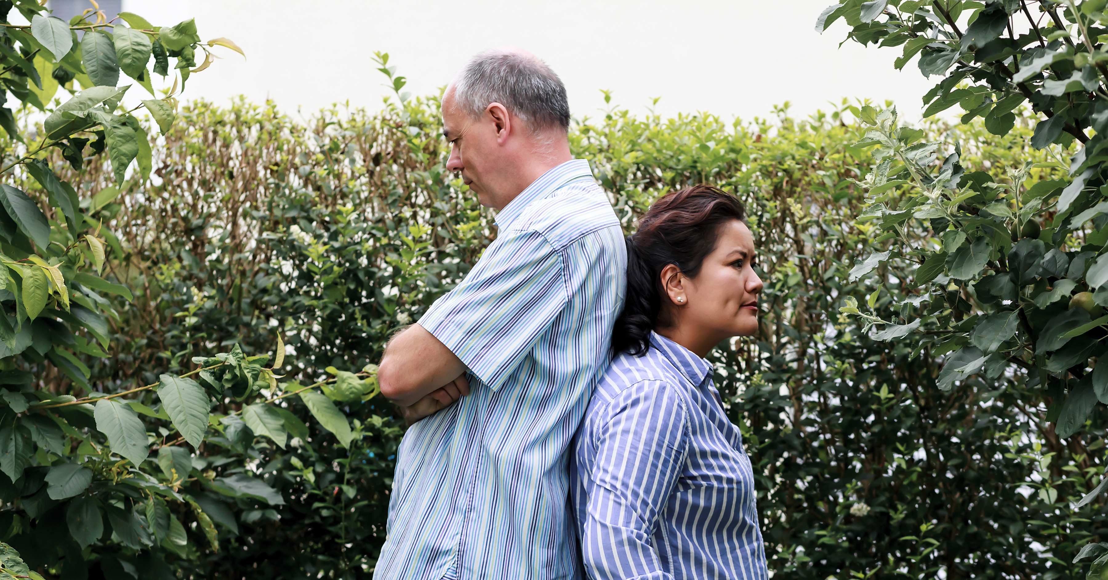 Couple with backs to each other looking frustrated with relationship